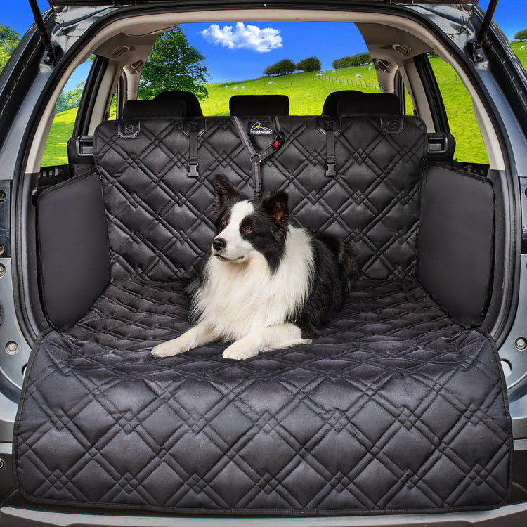 Long haired dog sitting on Meadowlark Cargo Liner Protector in trunk of vehicle.