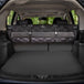 Meadowlark cargo liner rolled up and hanging on vehicle backseats in trunk.